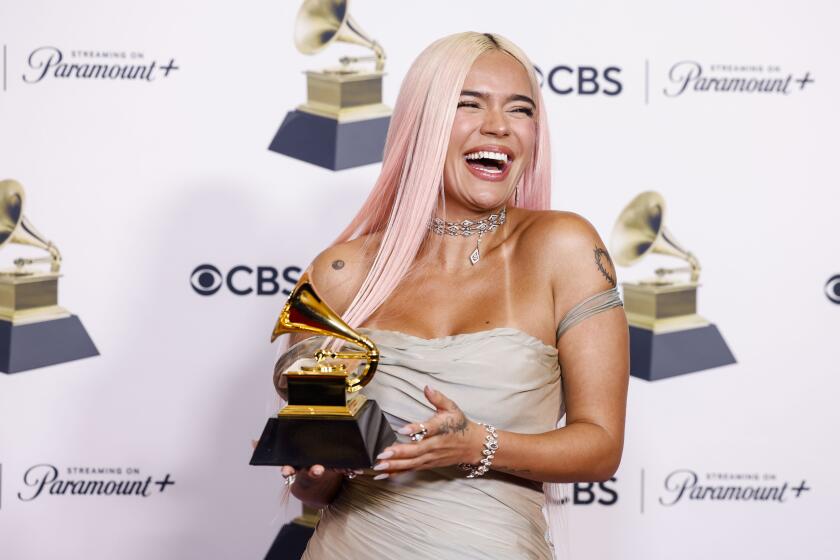 Los Angeles, CA - February 04: Winner Karol G, for "Manana Sera Bonito," with trophy, at the 66th Grammy Awards held at the Crypto.com Arena in Los Angeles, CA, Sunday, Feb. 4, 2024. (Jason Armond / Los Angeles Times)
