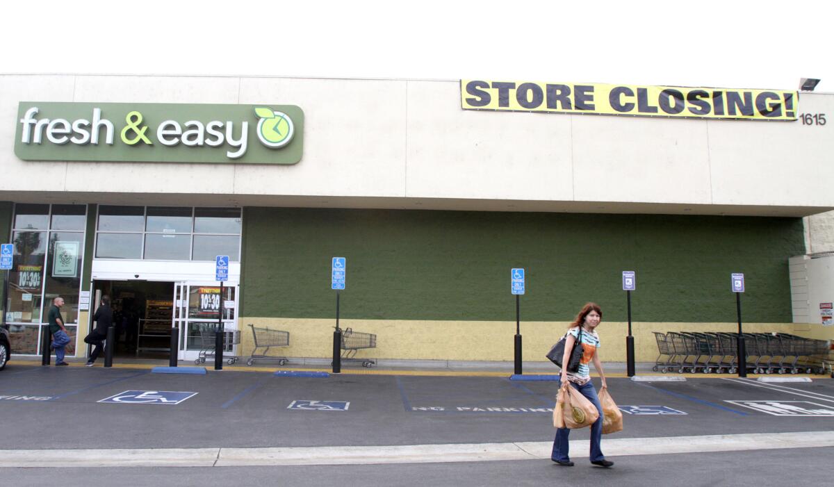 A customer walks out with bags of items from the Fresh & Easy store on the 1600 block of W. Verdugo Ave., where signs state the store is closing, on Tuesday, October 2, 2015. Most items in the store are discounted from 10% to 30%.