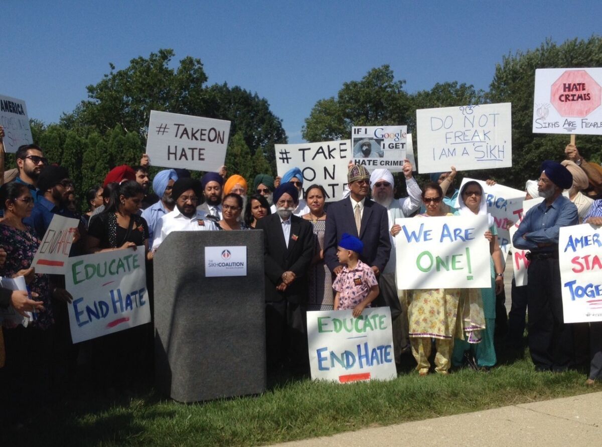 On Sept. 15, Inderjit Singh Mukker, at podium, speaks at a news conference in Darien, Ill., saying because of his brown skin, turban and beard, he was the victim of a beating.