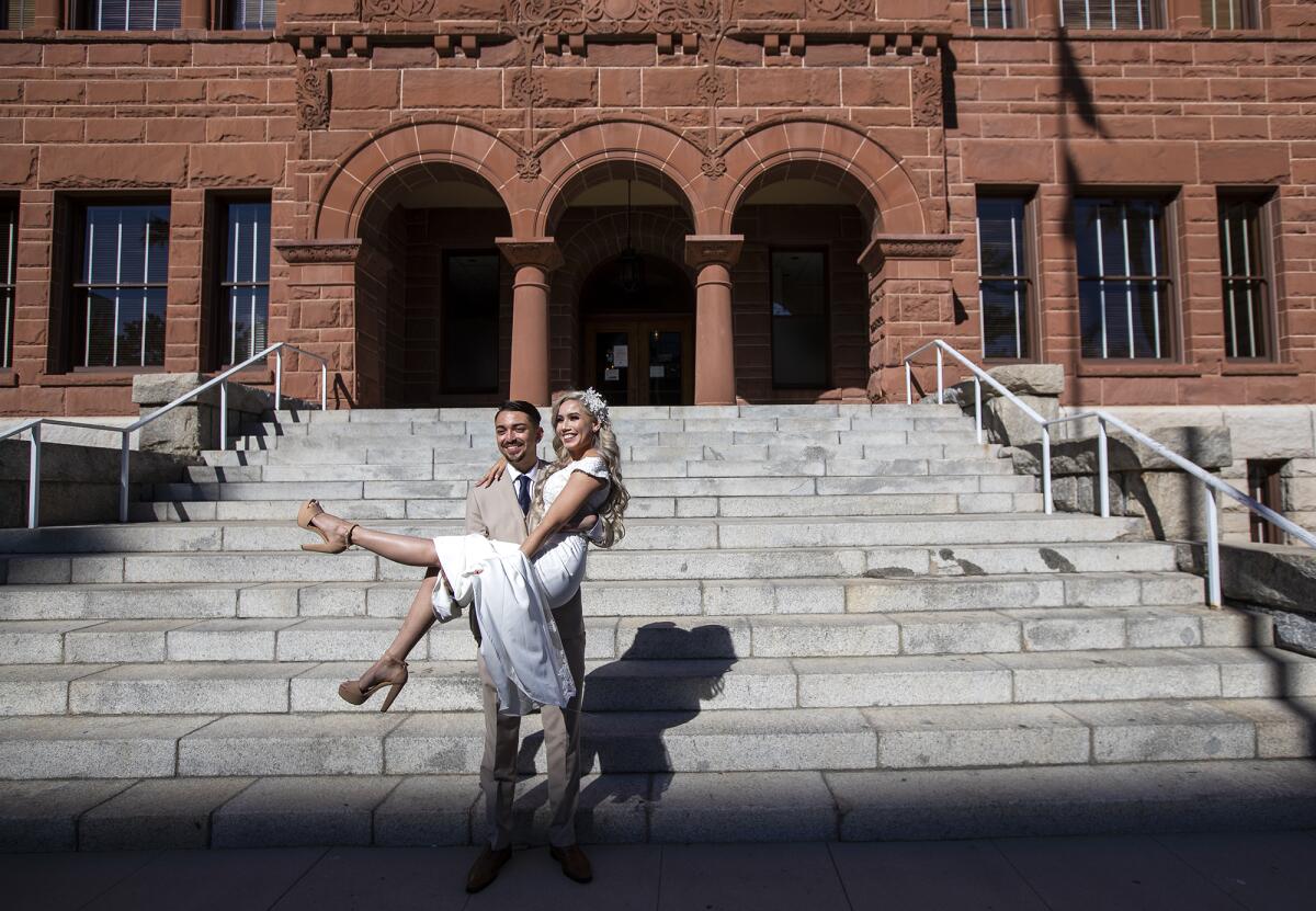 Alonso De La Torre and Viridiana Tapia pose at the Old Orange County Courthouse.