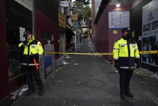 FILE- Police officers stand guard at the scene where dozens of people died and were injured during a crowd surge in Seoul, South Korea, on Oct. 30, 2022. South Korean police on Friday, Jan. 13, 2023, said they are seeking charges of involuntary manslaughter and negligence against 23 officials, for a lack of safety measures they said were responsible for a crowd surge that killed nearly 160 people in October. (AP Photo/Ahn Young-joon, File)