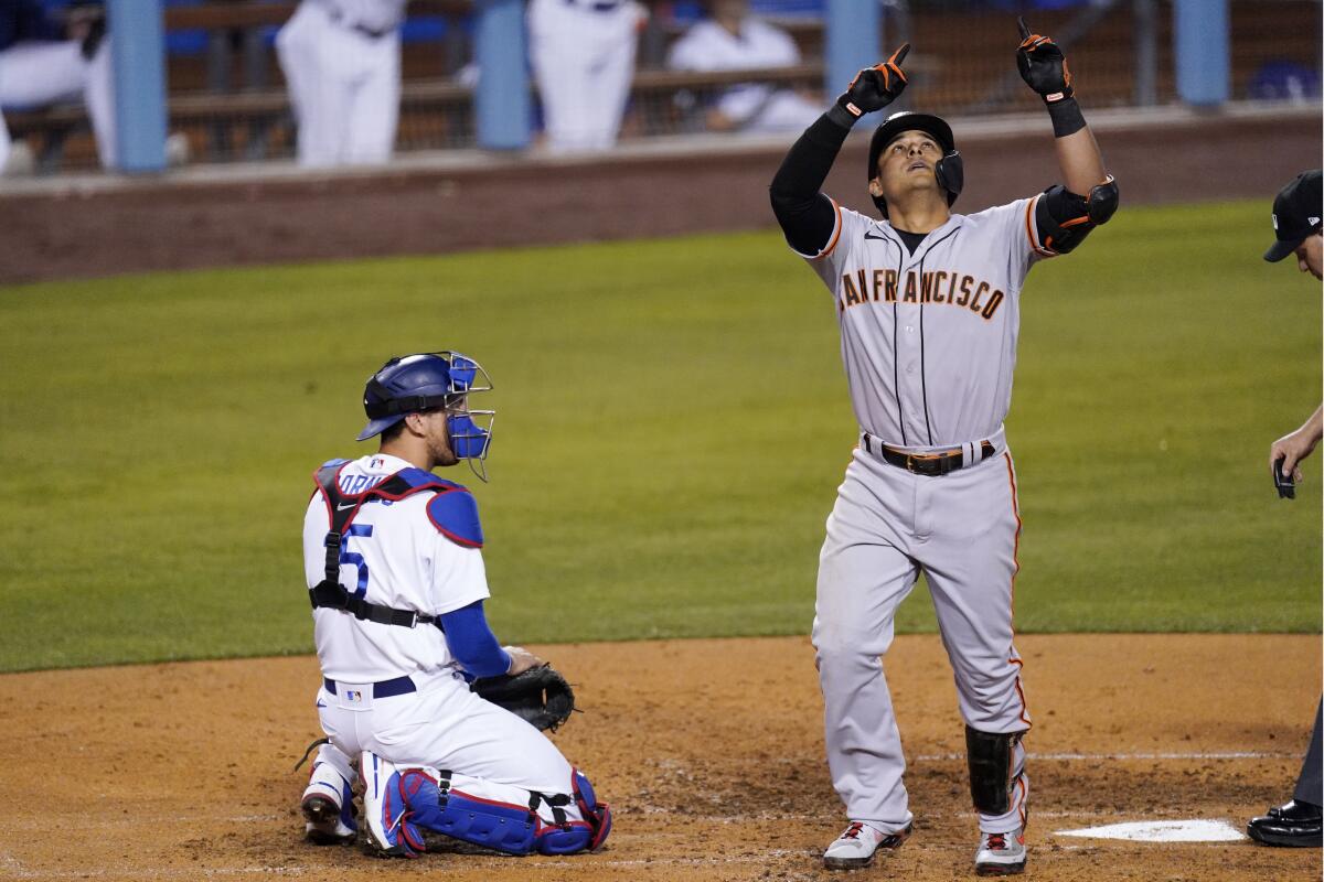 Giants second baseman Donovan Solano, right, gestures after hitting a two-run home run in the sixth inning.