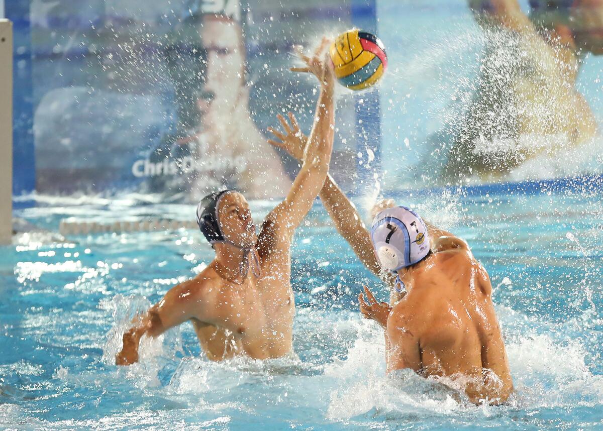Newport Harbor's Tommy Kennedy, left, blocks the shot by Corona del Mar's Tanner Pulice in the Battle of the Bay match on Wednesday at Corona del Mar High.