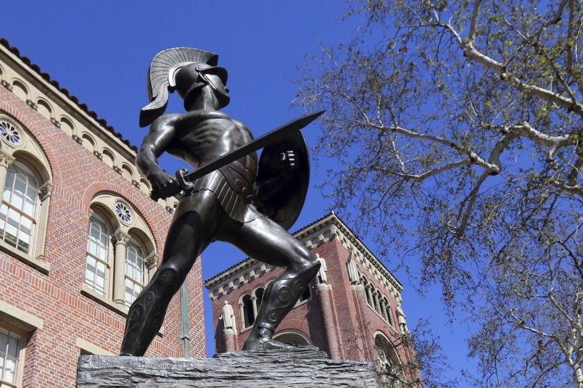 This Tuesday, March 12, 2019 photo shows the iconic Tommy Trojan statue at the University of Southern California in Los Angeles. USC is one of many colleges and companies moving swiftly to distance themselves from employees swept up in a nationwide college admissions scheme, many charged with taking bribes and others from well-to-do and celebrity parents accused of angling to get their children into top schools. By Wednesday, March 13, USC had fired senior associate athletic director Donna Heinel and water polo coach Jovan Vavic. USC's interim President Wanda Austin said about a half-dozen current applicants affiliated with Singer's firm will be barred from admission. (AP Photo/Reed Saxon)may be connected to the scheme alleged by the government. (AP Photo/Reed Saxon)