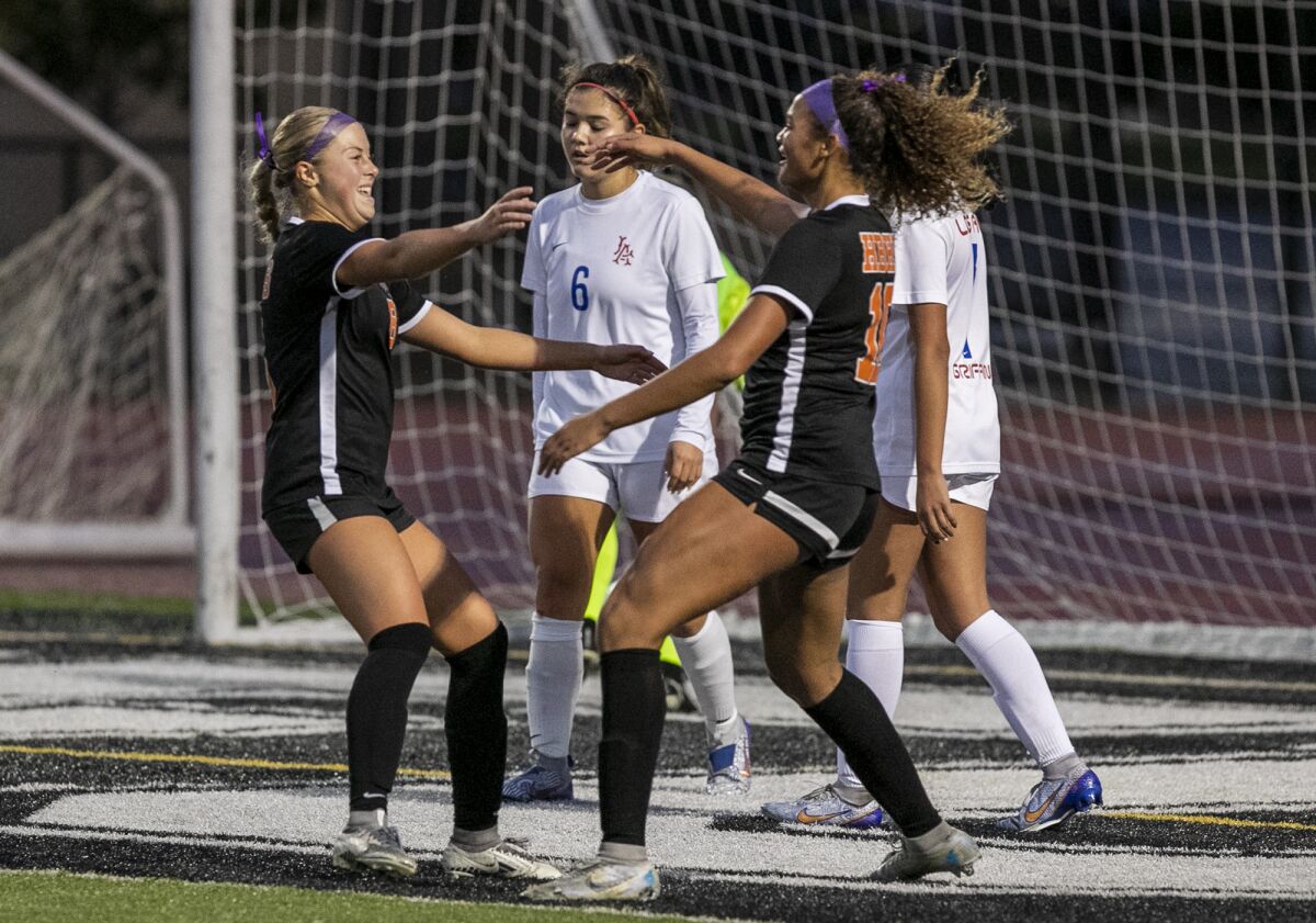 Huntington Beach's Hannah Petteys, left, celebrates a goal with Jaiden Anderson during Monday's match.