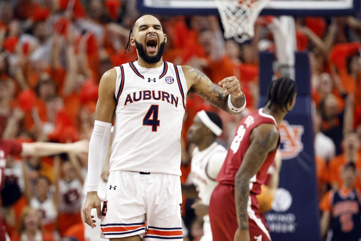 Auburn forward Johni Broome reacts after a basket during the first half of an NCAA college basketball game against the Alabama, Wednesday, Feb. 7, 2024, in Auburn, Ala. (AP Photo/ Butch Dill)