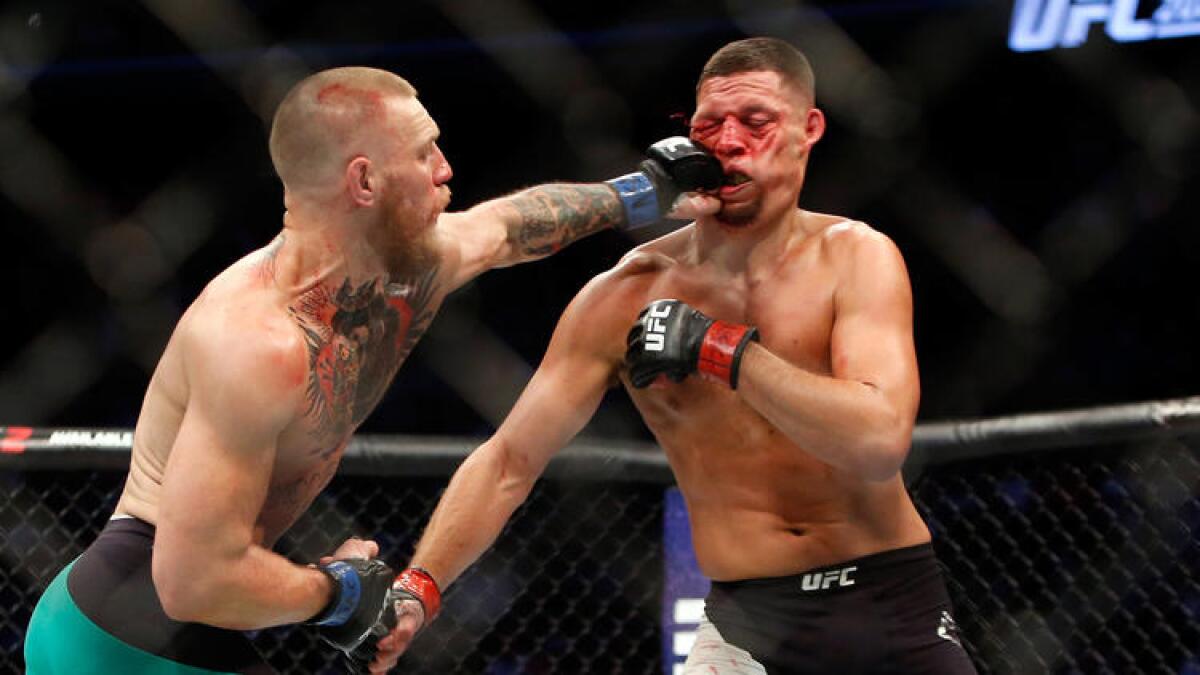 Conor McGregor lands a left to the face of Nate Diaz during their welterweight rematch at UFC 202
