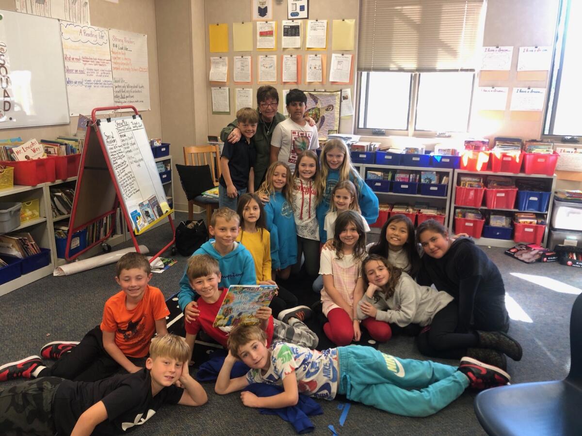 Author Adrienne Falzon (back row, center) with some students at R. Roger Rowe School.