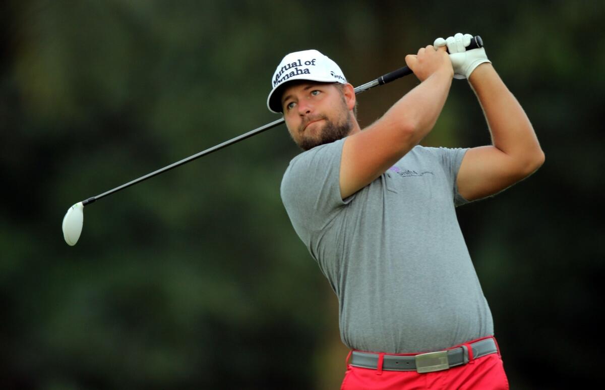 Ryan Moore, above, defeated Gary Woodland on the first playoff hole Monday at the CIMB Classic in Malaysia.