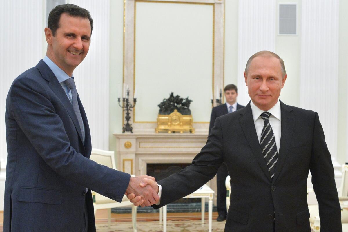 Syrian President Bashar Assad shakes hands with Vladimir Putin in Moscow on Oct. 21. Since the Russian aerial campaign began Sept. 30, loyalist forces have gone on the offensive, winning back territory.