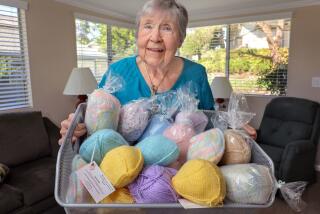 September 10, 2018, Escondido, California_USA_| Pat Anderson holds a basket full of her various "Busters" wardrobe accessories for breast cancer survivors. |_Photo Credit: Photo by Charlie Neuman