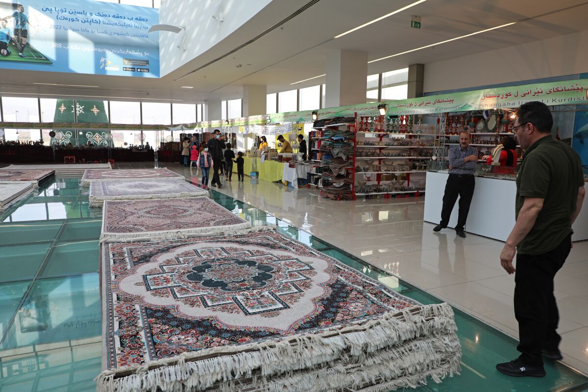 Piles of plush Iranian-made carpets line the floors of a shopping center in Dahuk in northern Iraq.