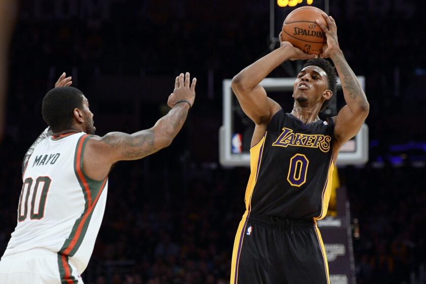 Lakers guard Nick Young pulls up for a shot against Bucks guard O.J. Mayo in the first half.