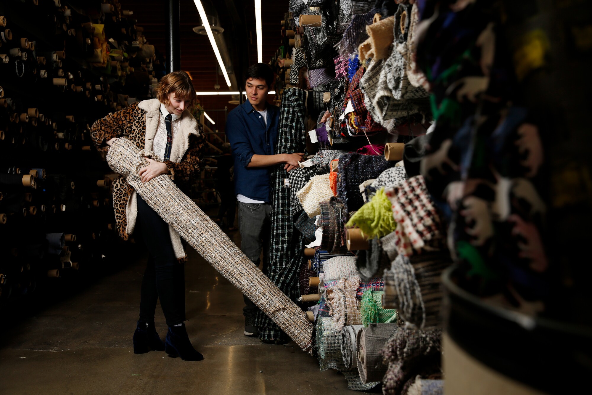 Soline Gautheir, left, and Sam Wong, right, choose fabrics at Mood Fabrics.