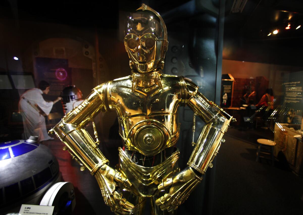 A flurry of new books will tell "Star Wars" fans what happened to characters (such as C-3PO, pictured here at the Discovery Science Center) before "The Force Awakens."