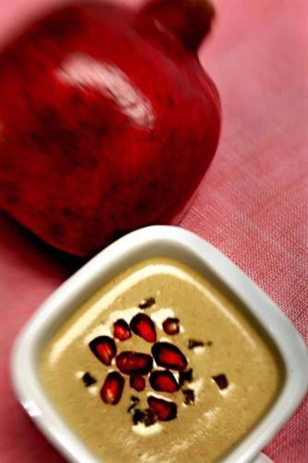 Walnut soup with poblanos and pomegranate is a twist on the Mexican dish chiles en nogada, picadillo-stuffed poblanos in a creamy walnut sauce accented with pomegranate seeds.