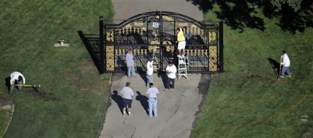 Members of the grounds crew work on a gate at Neverland Ranch in Los Olivos, Calif., Wednesday, July 1, 2009 as preparations are made for a possible memorial service for the late pop star Michael Jackson at his former residence. (AP Photo/Chris Carlson)