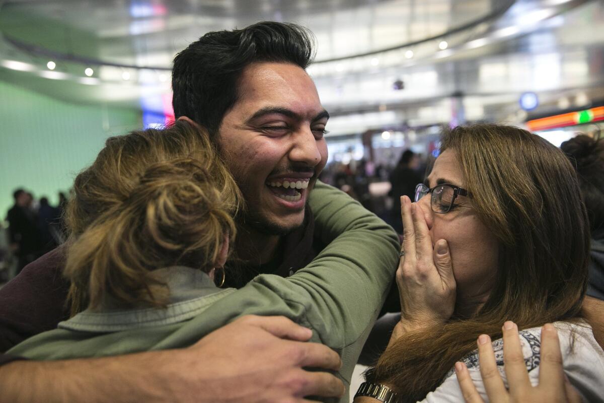 Abdullah Al-Rifaie is greeted by family at LAX on Sunday during a court stay of the Trump administration's executive order banning travel from seven Muslim-majority countries.