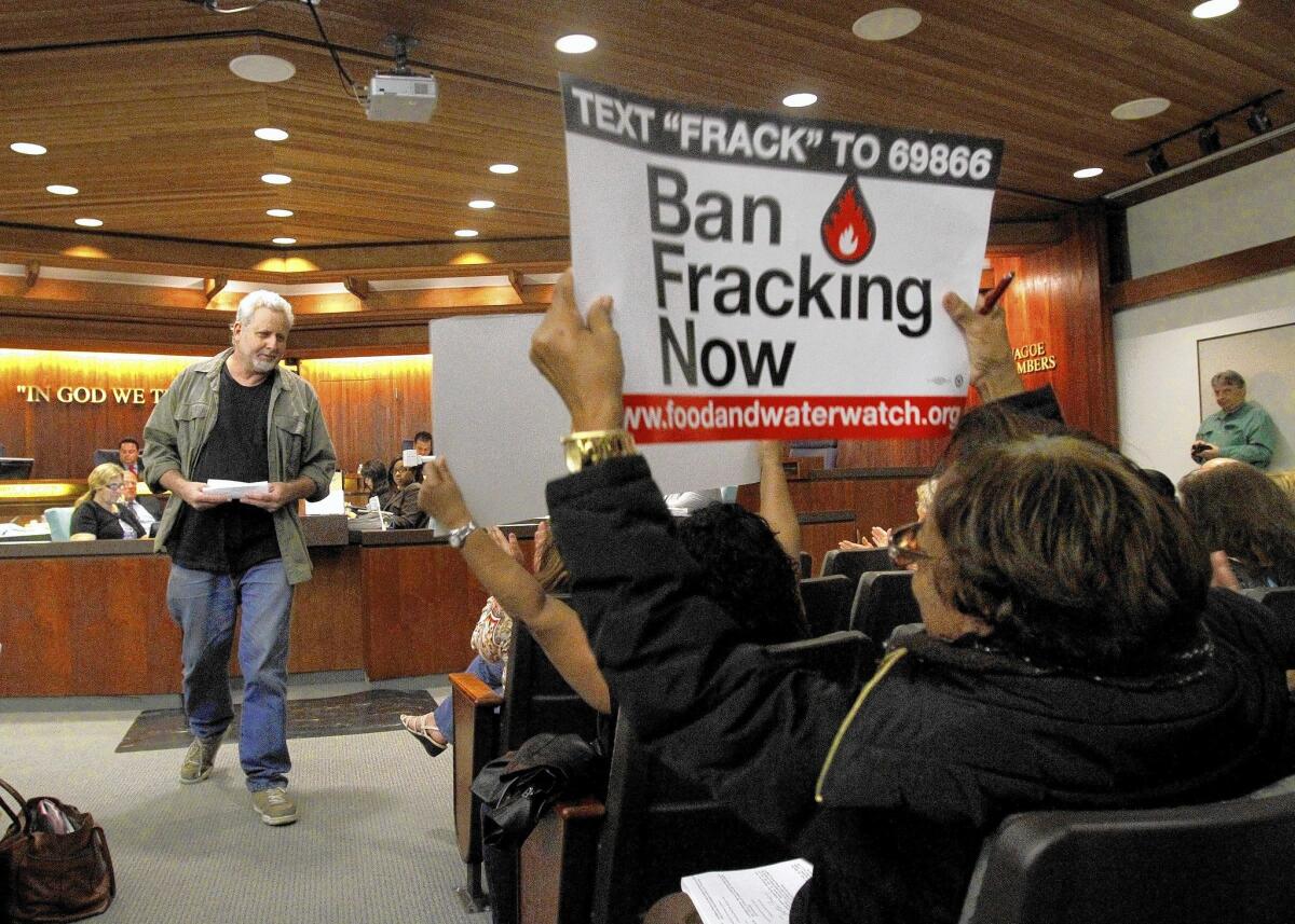 Glenn White leaves the lectern after speaking against new oil and gas production in Carson during a March council meeting. The city's temporary ban on oil drilling will expire Friday.