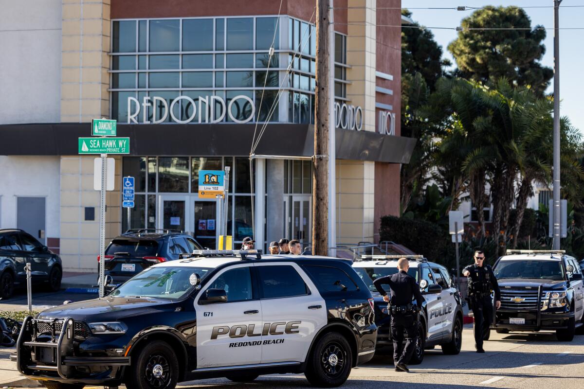 Three police vehicles outside a building that says "Redondo Union."