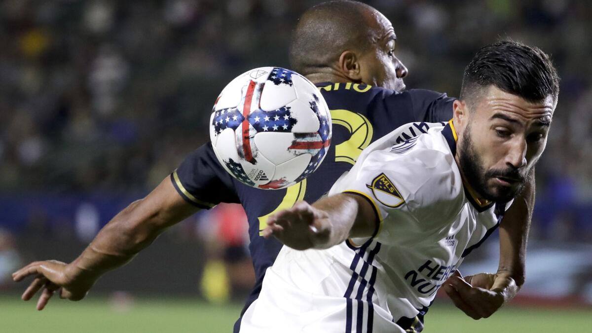 Galaxy midfielder Romain Alessandrini, right, vies for the ball with Philadelphia Union defender Fabinho during the second half of a match on April 29.