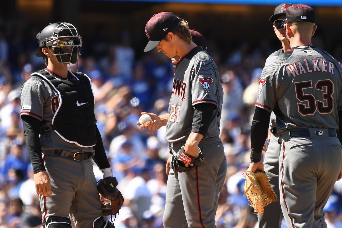 Diamondbacks pitcher looks at the ball after giving up a home run to Dodgers Corey Seager in the 4th inning at Dodger Stadium.