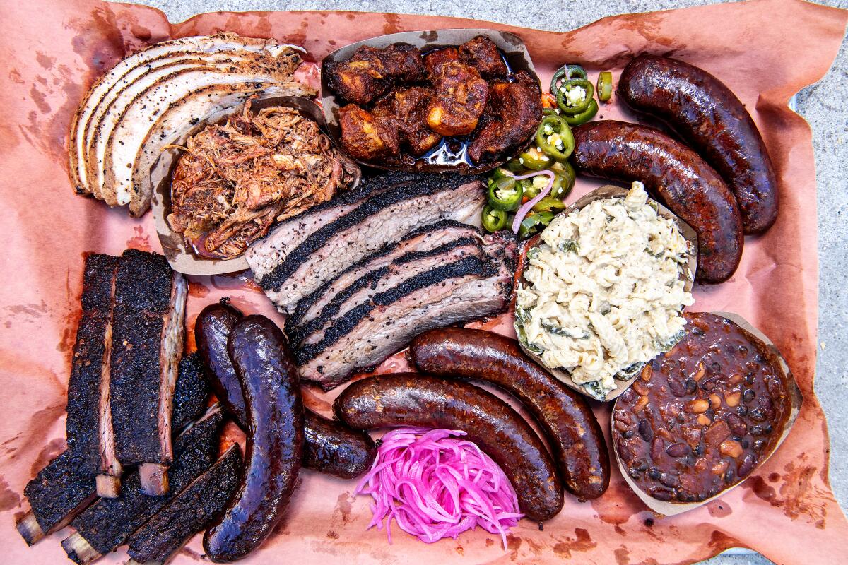 A platter with a variety of meats and sides 