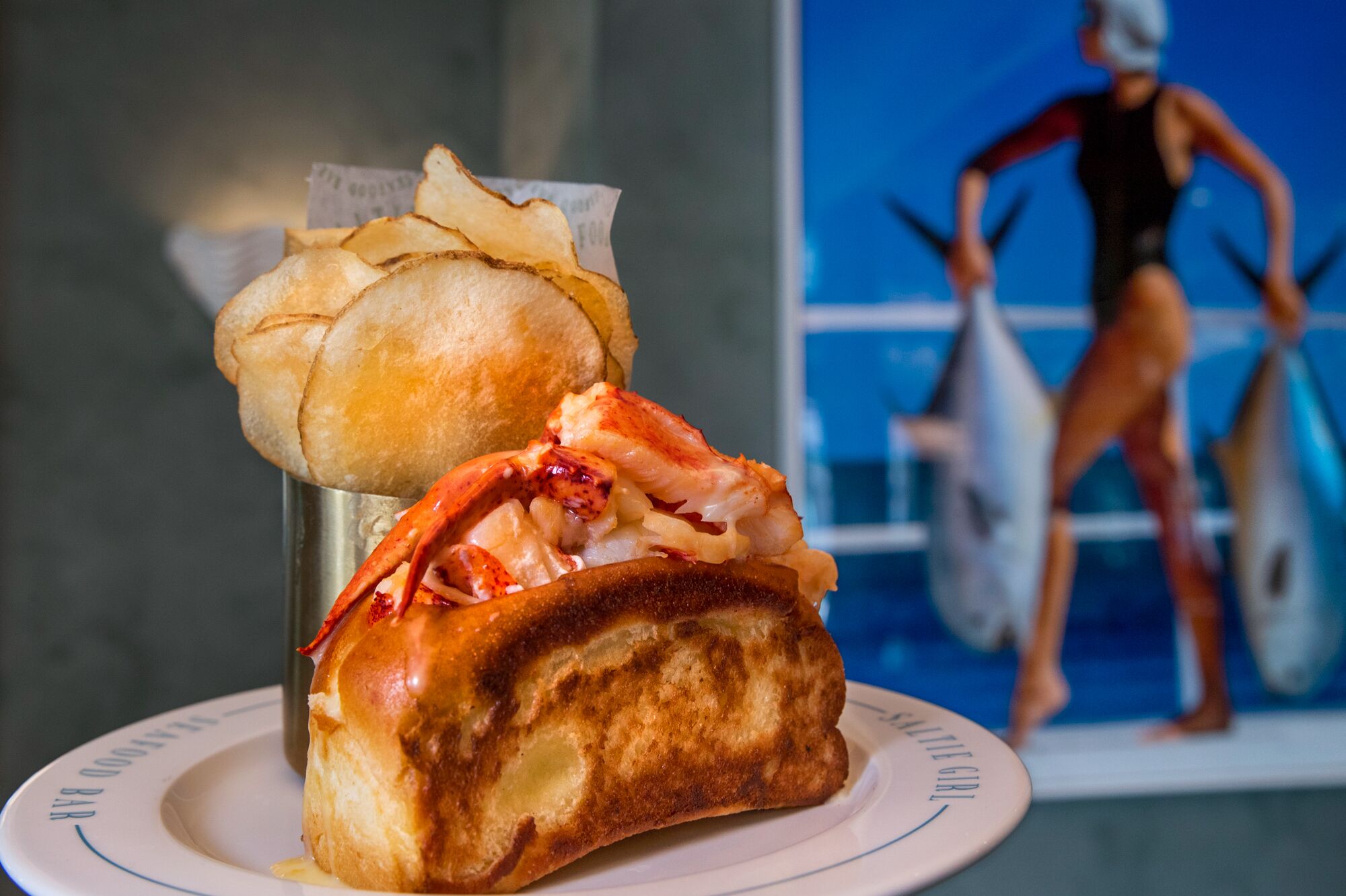 A warm lobster roll with house made salt and vinegar chips 