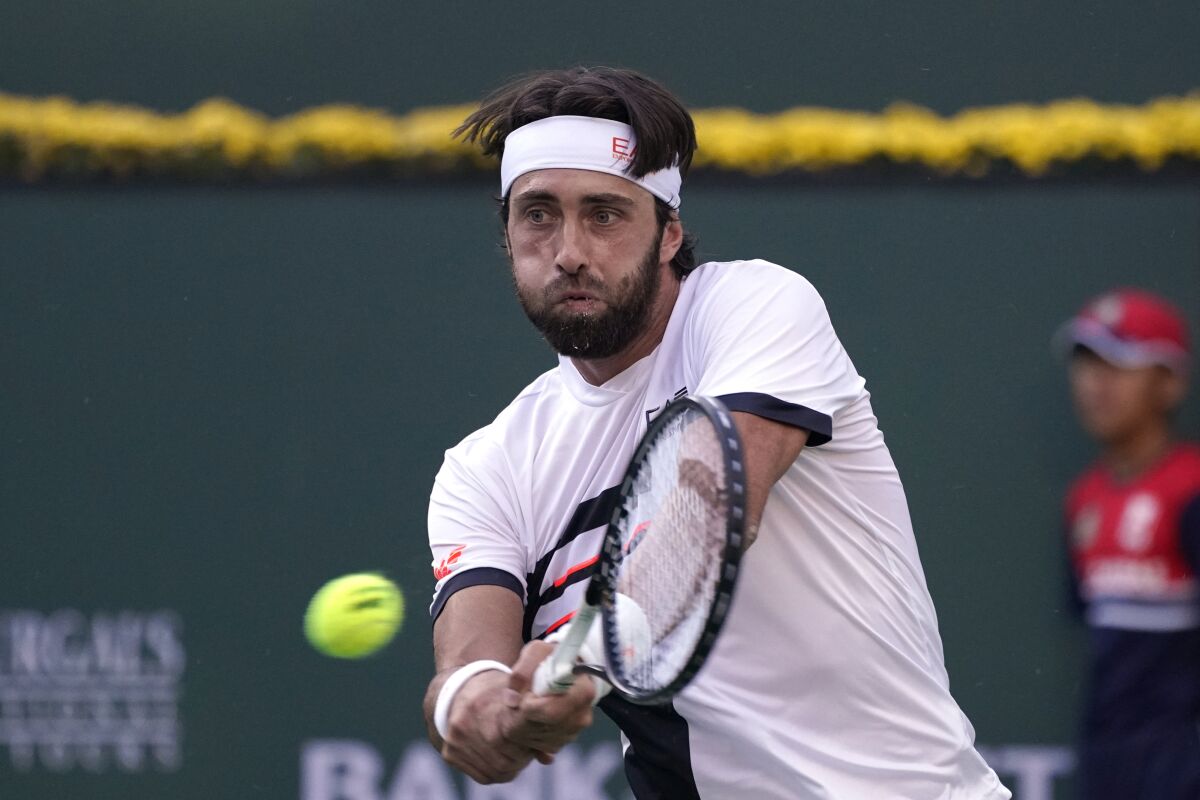 Nikoloz Basilashvili, of Georgia, returns to Taylor Fritz, of the United States, in a semifinal at the BNP Paribas Open tennis tournament Saturday, Oct. 16, 2021, in Indian Wells, Calif. (AP Photo/Mark J. Terrill)