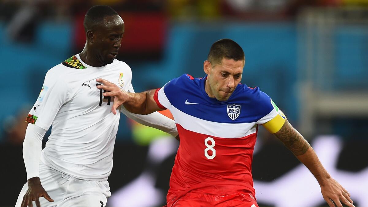 U.S. forward Clint Dempsey, right, controls the ball in front of Ghana's Albert Adomah during the United States' win on June 16.