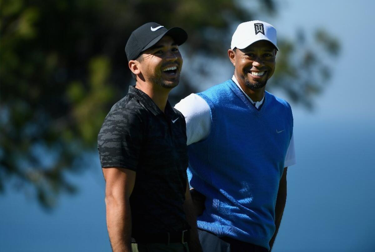 Jason Day, left, and Tiger Woods share a laugh on the fourth hole during the first round of the Farmers Insurance Open at Torrey Pines South on Jan. 26.