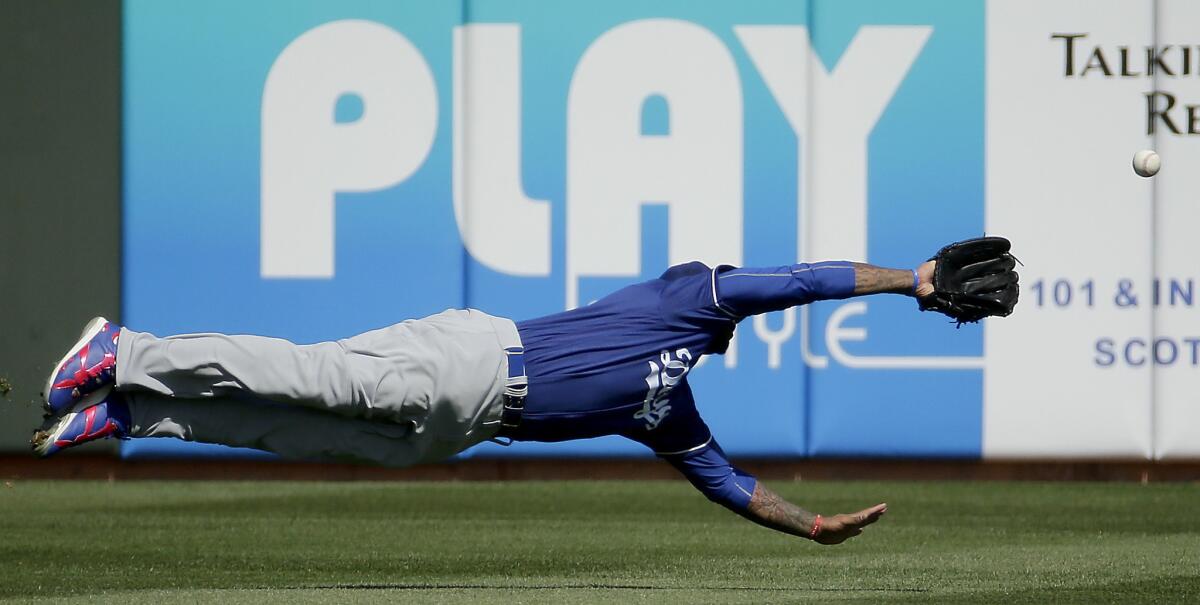 Dodgers left fielder Carl Crawford dives for but misses a double hit by Rangers outfielder Delino DeShields during the first inning of a spring training game on March 4.