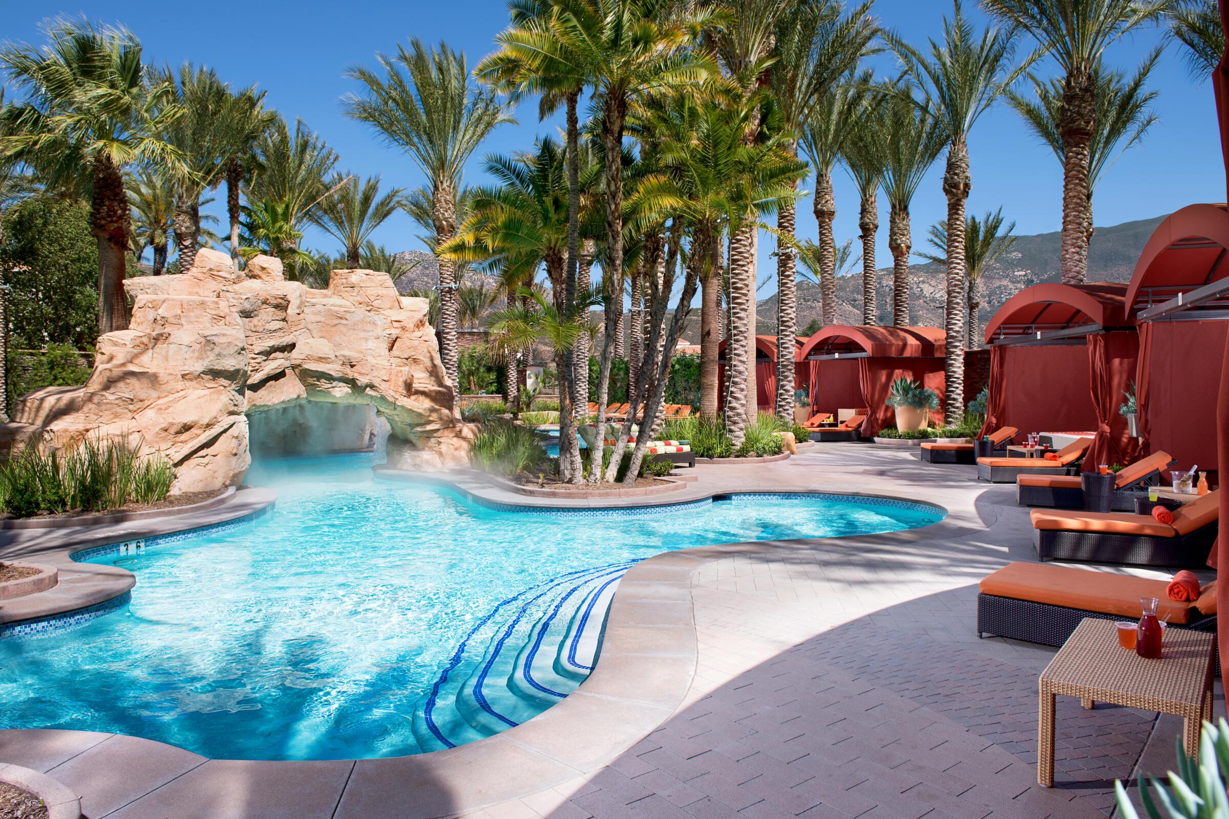 The grotto area of the lazy river at Harrah's Resort Southern California. It also features cabanas and daybeds.
