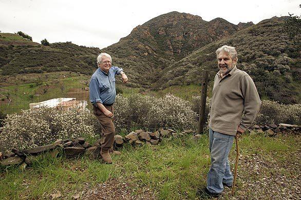 Agoura residents Nick Noxon, 72, left, and Paul Culberg, 66, point out the view from Culberg's backyard. In the background is the volcanic peak known as Negrohead Mountain, which county officials want to rename Ballard Mountain in honor of pioneering black settler John Ballard.