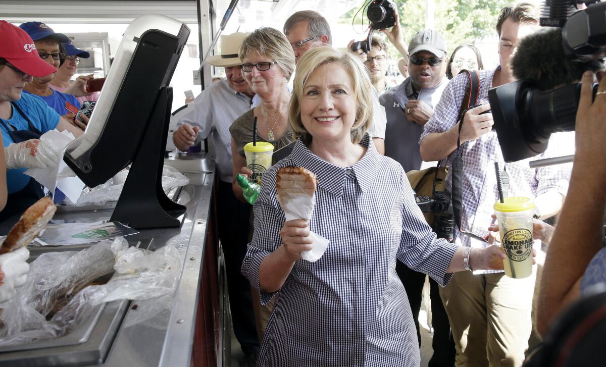 Democratic presidential candidate Hillary Rodham Clinton leaves a pork chop stand during a visit to the Iowa State Fair in Des Moines on Saturday.