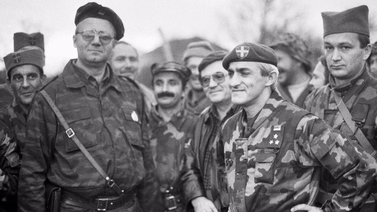 Dragan Vasiljkovic, better known as Captain Dragan, second from right, and the president of the ultra-national Serbian Radical Party Vojislav Seselj at the battle field in Benkovac city in Croatia, in 1991.