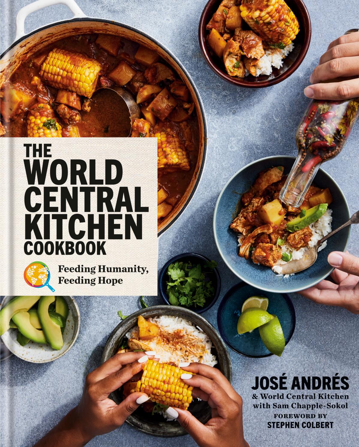 The cover of the World Central Kitchen cookbook. Hands pour hot sauce a lift food. A stew in a pot in one corner.