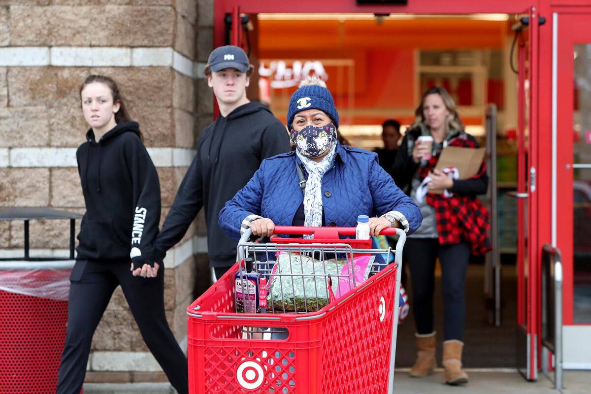 Shoppers leave the Target along Harbor Boulevard on Tuesday in Costa Mesa.