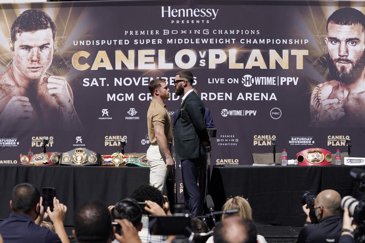 Canelo Álvarez faces off with Caleb Plant during a news conference