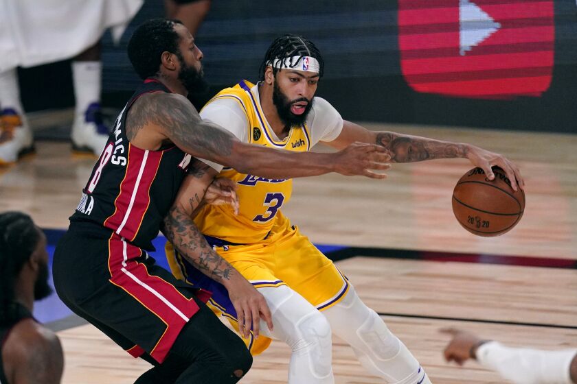 Los Angeles Lakers' Anthony Davis (3) is covered by Miami Heat's Andre Iguodala (28) as he rolls to the hoop during the first half of Game 1 of basketball's NBA Finals Wednesday, Sept. 30, 2020, in Lake Buena Vista, Fla. (AP Photo/Mark J. Terrill)