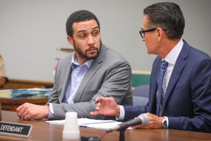 Former NFL player Kellen Winslow II, left, who faces up to 18 years in prison after pleading guilty on rape and other charges, talks to his defense attorney, Marc Carlos, right, during a sentencing hearing in the San Diego County Superior Court Judge Blaine Bowman, February 19, 2020 in Vista, California. The sentencing was continued until March.