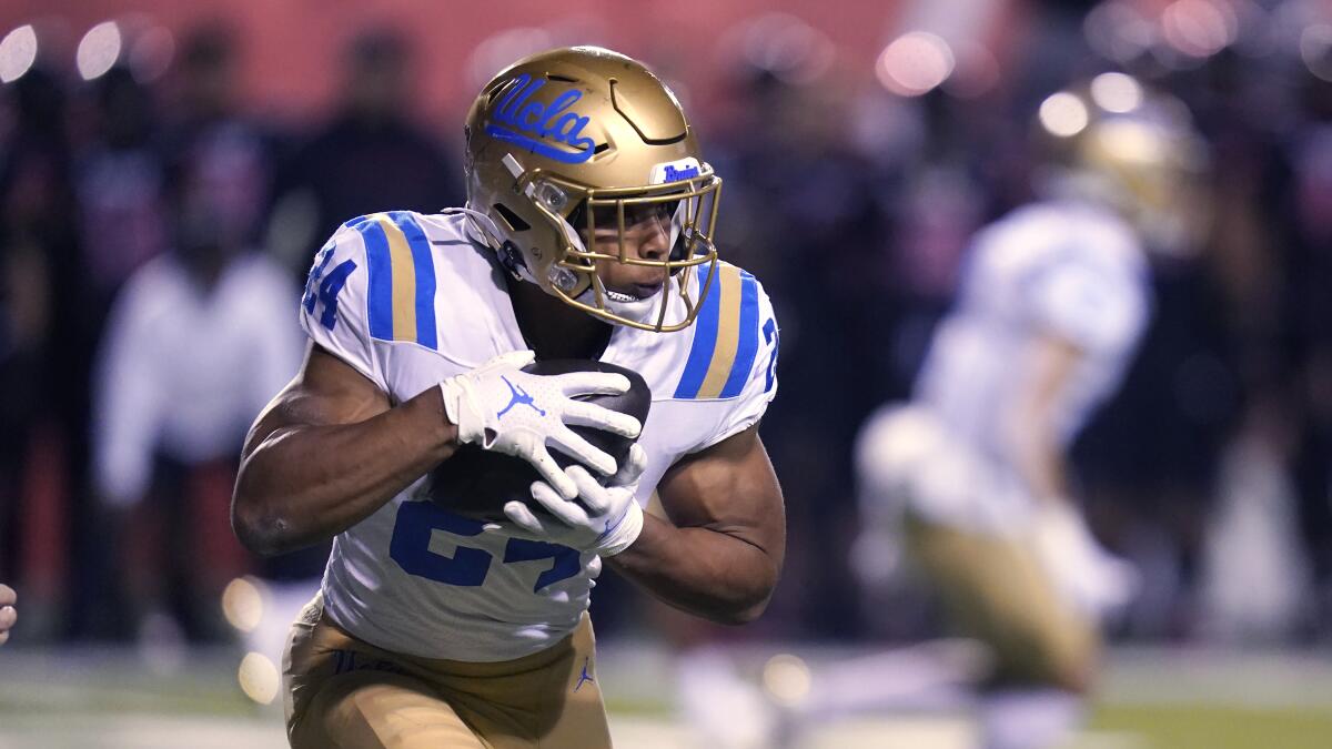 UCLA running back Zach Charbonnet (24) carries the ball in the first half.