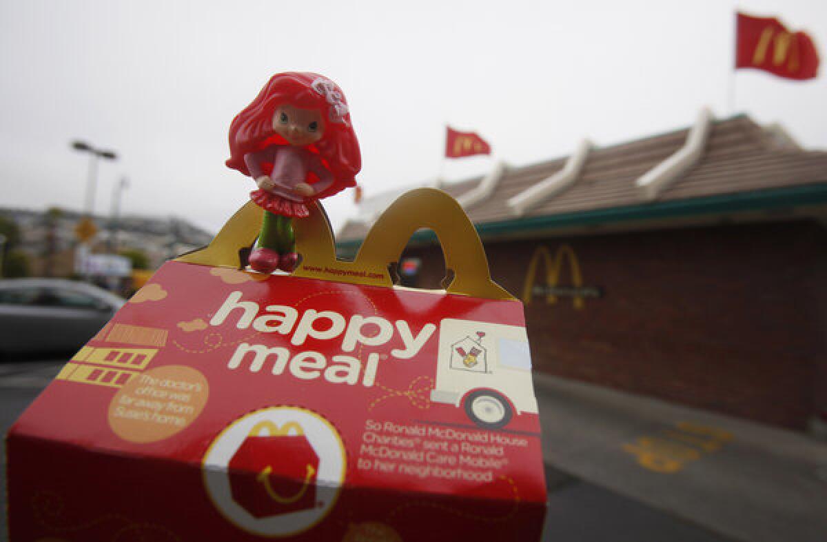McDonald's has pledged to distribute 15 million books in its Happy Meals in England over the next two years.