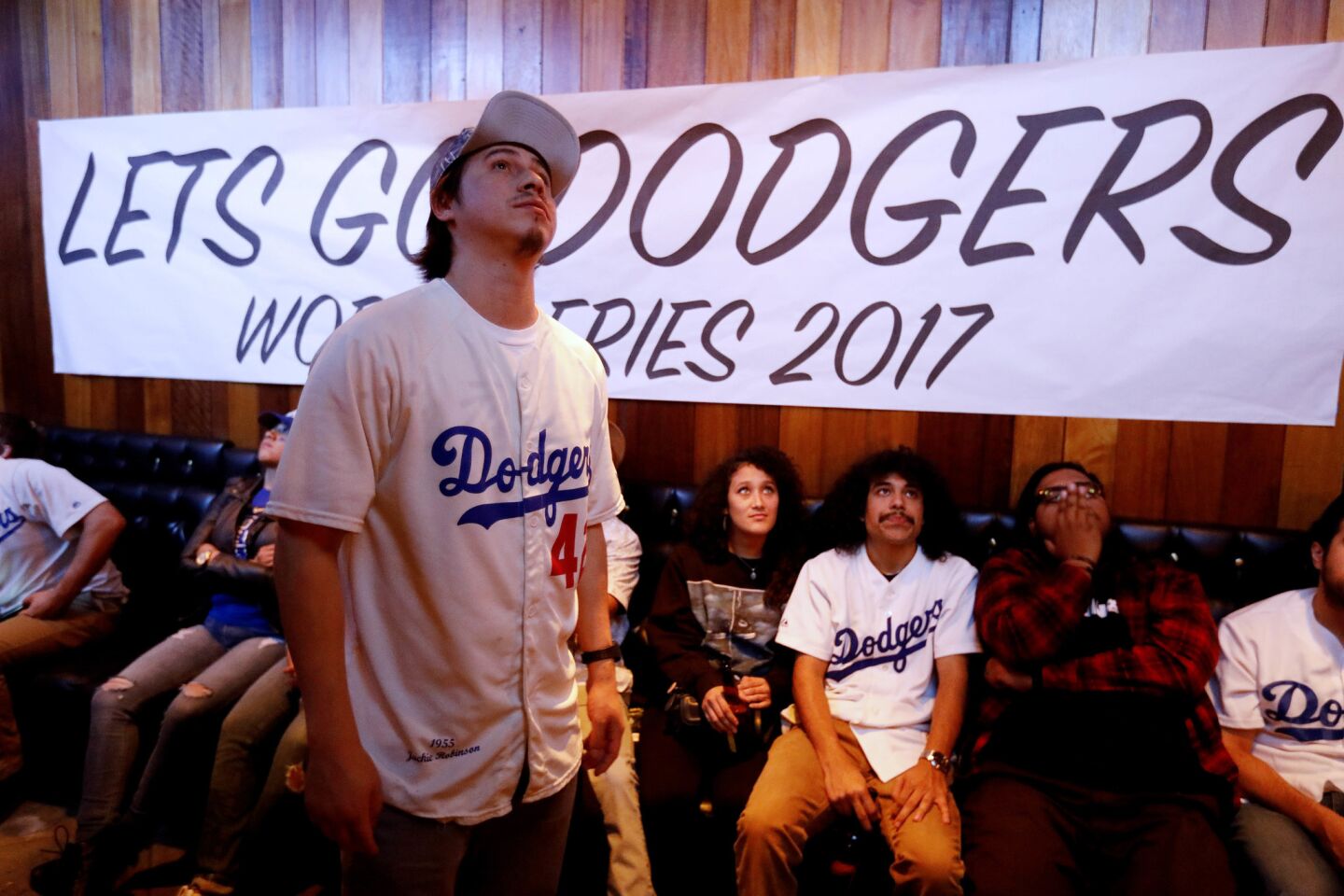 Mescal Miranda, left, of Los Angeles, along with other fans watch Game 7 at the Short Stop in Los Angeles.