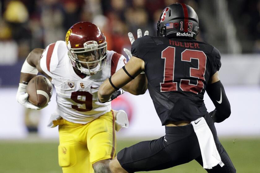 USC receiver JuJu Smith-Schuster straight-arms Stanford cornerback Alijah Holder in the Pac-12 championship Dec. 5.
