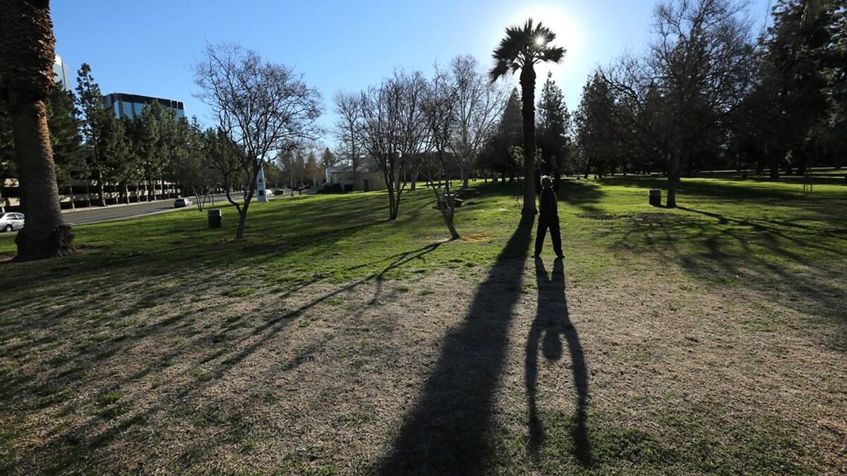 Dilip Ray performs jumping jacks during his daily workout at Warner Park in Woodland Hills. Warm temperatures and high winds are expected today.