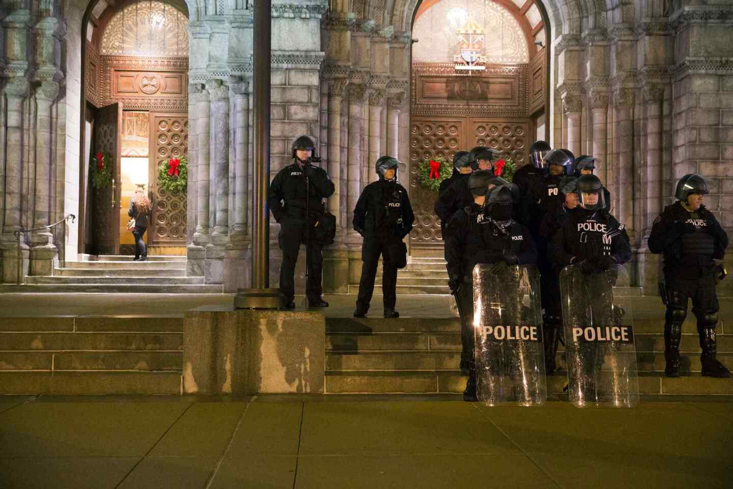 Police stand guard during a protest at Cathedral Basilica in St. Louis, Missouri on December 25, 2014, days after a man was fatally shot at a suburban gas station by a police officer.
