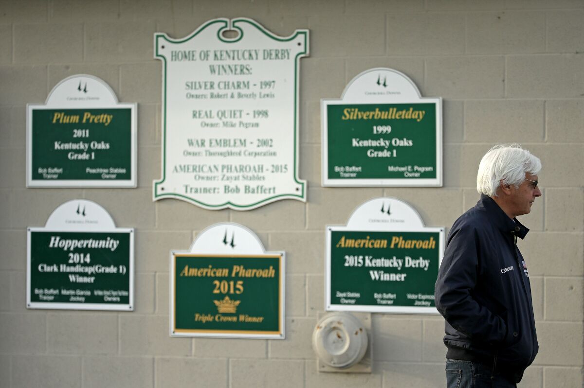 FILE - Trainer Bob Baffert stands outside his barn at Churchill Downs Monday, May 2, 2016, in Louisville, Ky. Medina Spirit was stripped of the victory in last years Kentucky Derby and Mandaloun was declared the winner in a ruling by state racing stewards on Monday, Feb. 21, 2022. (AP Photo/Charlie Riedel, FIle)