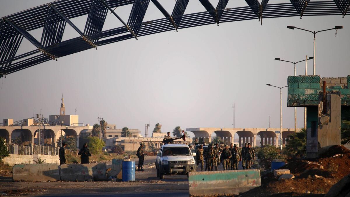 Syrian government soldiers arrive at the Nasib border crossing on July 6, 2018.