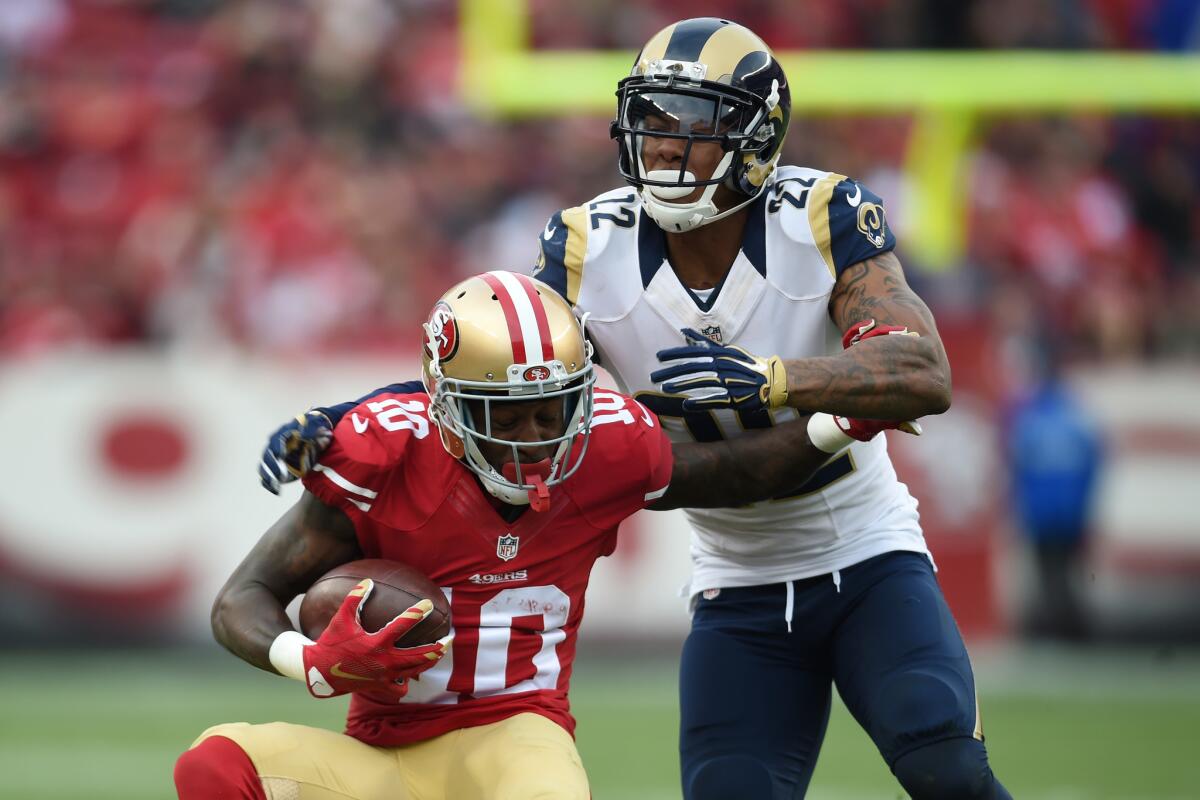 The Rams' Trumaine Johnson, right, tries to take down San Francisco's Bruce Ellington during a game on Jan. 3.